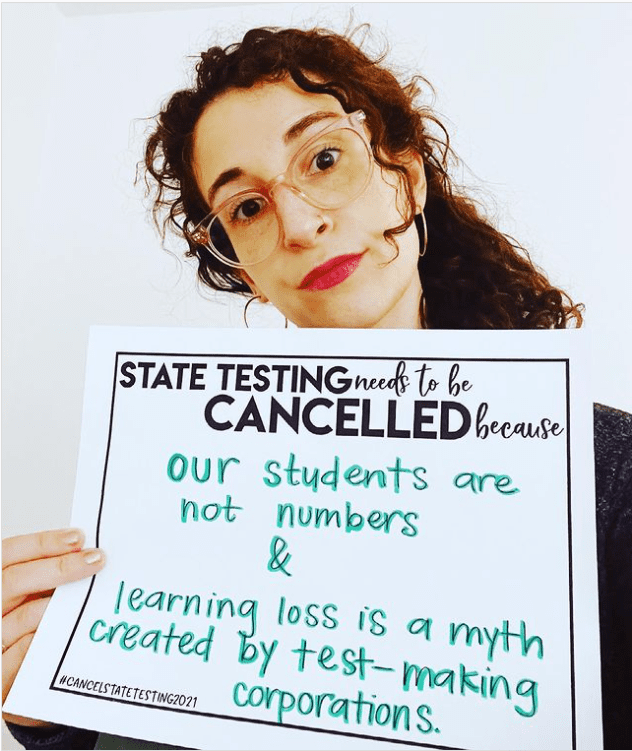 Teacher holding sign about the myth of learning loss to support canceling state testing in 2021