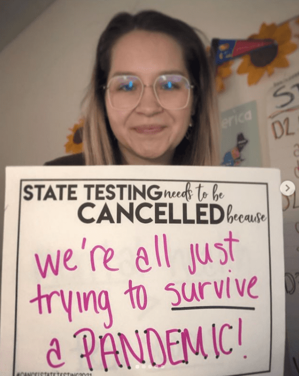 Teacher holding sign about surviving pandemic