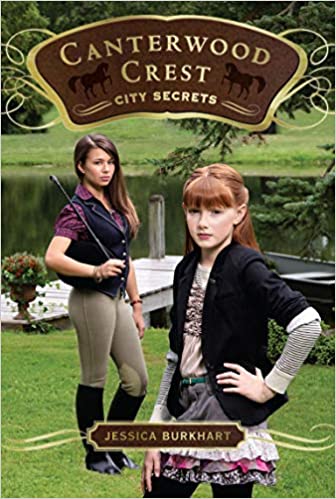 Book cover: Canterwood Crest: City Secrets.  A girl around 13 is shown in the foreground in riding gear with her hand on her hip and a stern look.