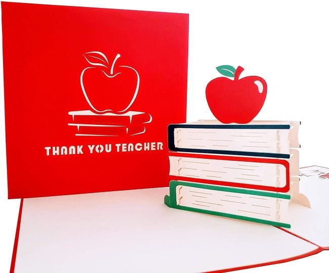 Greeting card that opens to display 3D book stack with apple on top