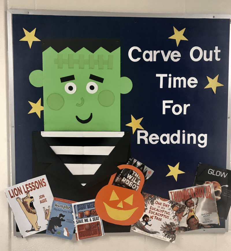 A cute frankenstein is shown on a black background. White letters say "Carve Out Time for Reading." There are books underneath.