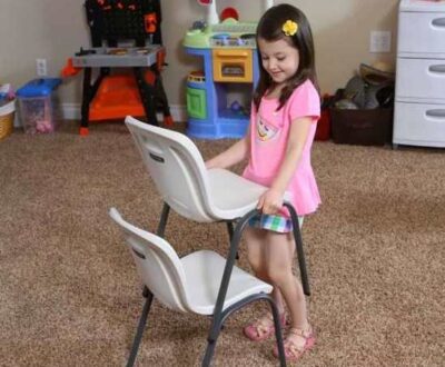 girl stacking plastic chairs