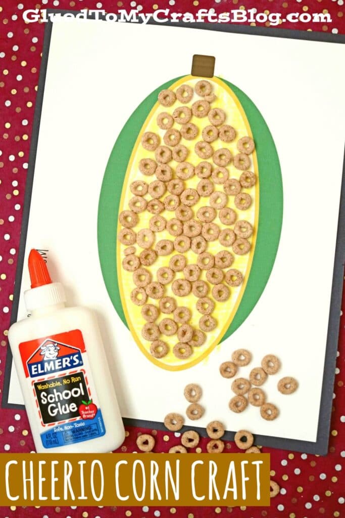 A corn template has cheerios glued to it to look like corn kernels.