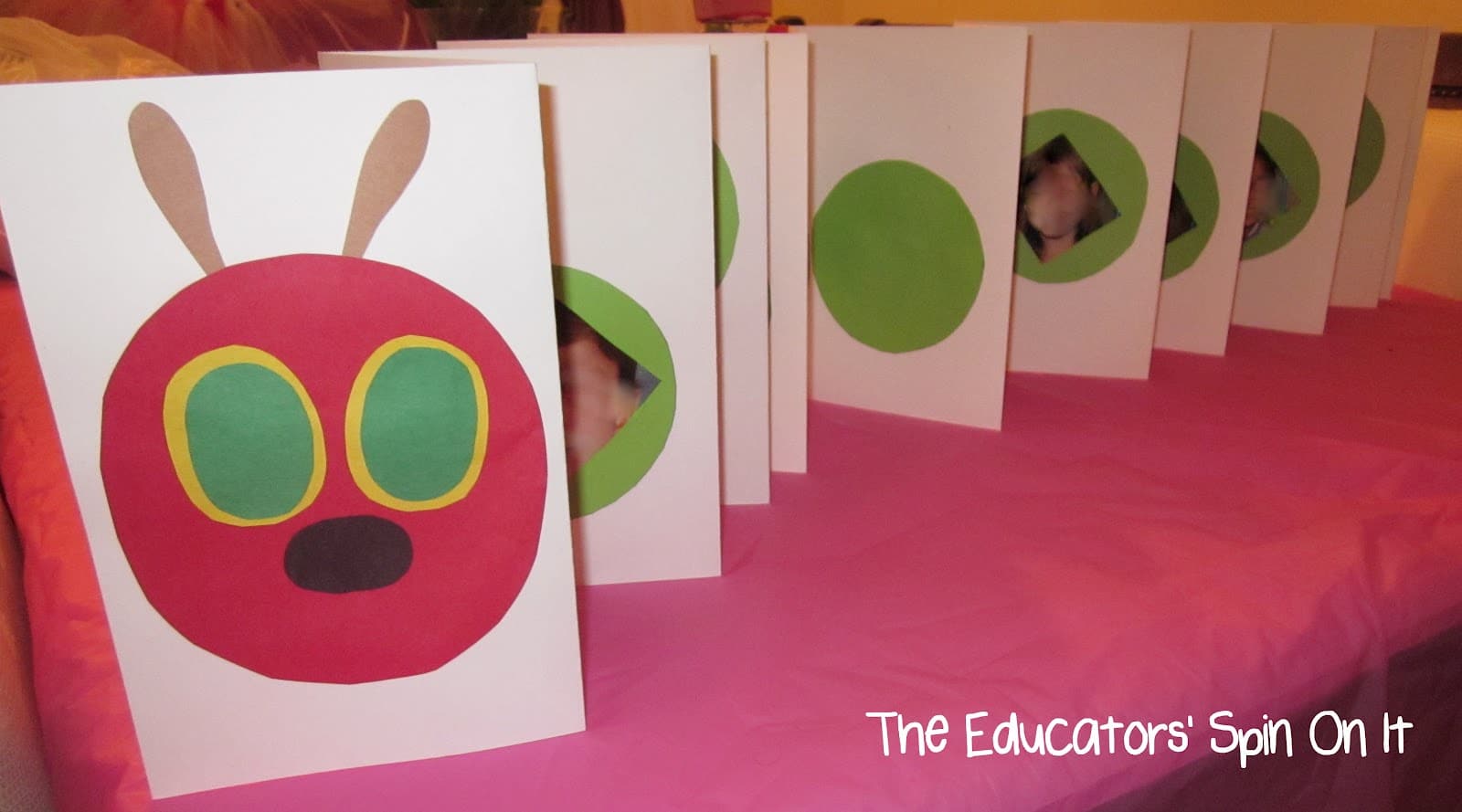 A caterpillar craft made from ten sheets of card stock, one for the head and 9 for the body