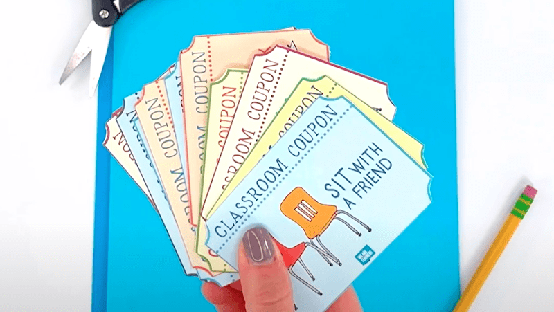 Hand holding classroom coupons