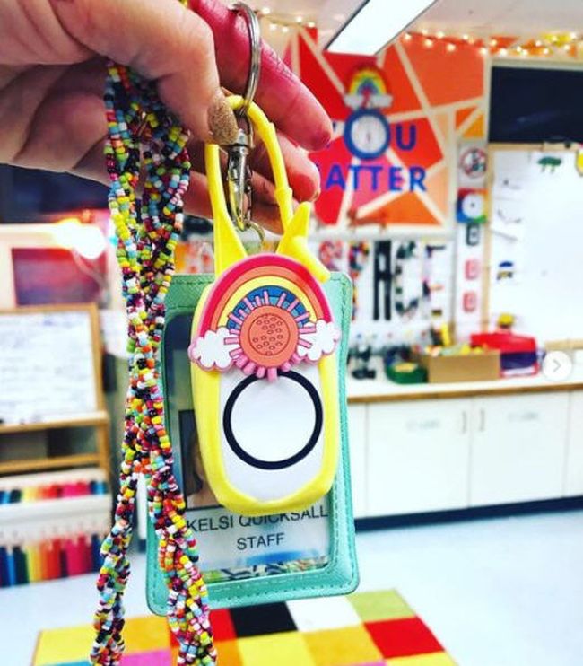 Teacher lanyard with ID and wireless classroom doorbell remote in a rainbow adorned holder