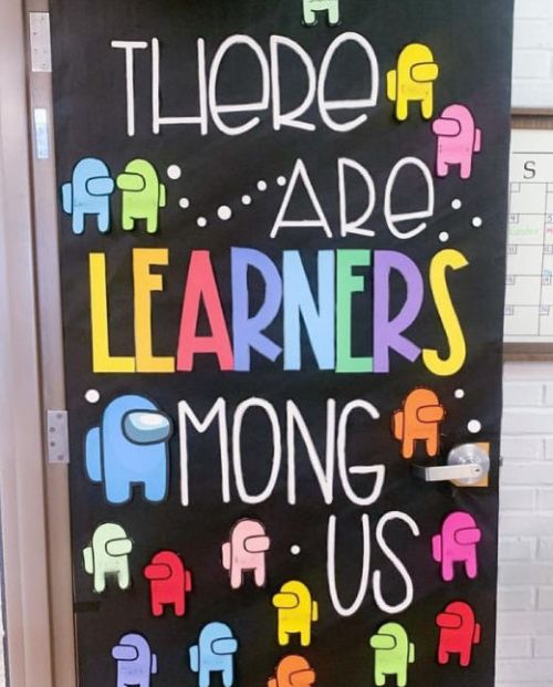Door decorated with Among Us crew members. Text reads There are learners among us.