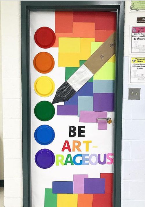 Door decorated with colorful paper and plastic plates to look like a paint palette. Text reads Be art-rageous.