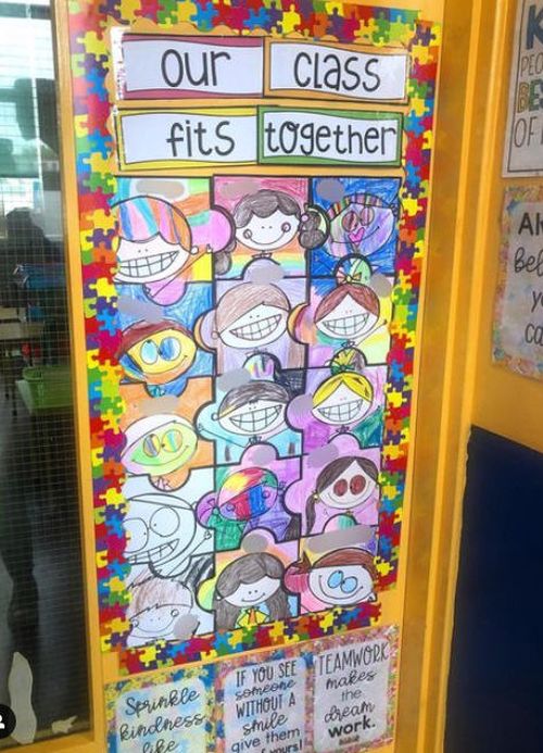 Door decoration with faces turned into puzzle pieces. Text reads Our Class Fits Together.