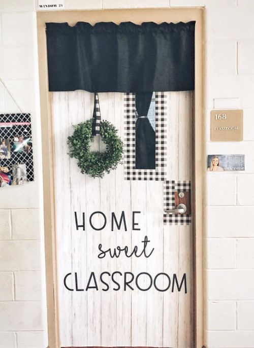 Classroom door decorated to make it look like a home door with a wreath. Text reads home sweet classroom.