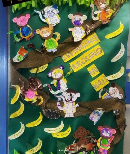 Classroom door with branch made of burlap and individually decorated paper monkeys.
