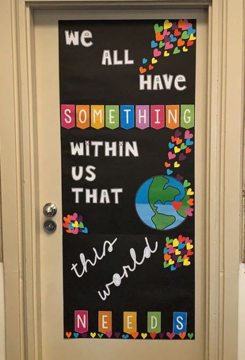 Classroom door decorated with a picture of the earth. Text reads: We all have something within us the world needs.