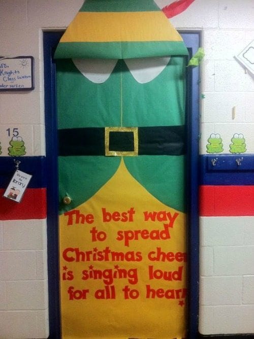 Classroom door decorated to look like Buddy the Elf, with text reading "The best way to spread Christmas cheer is singling loud for all to hear!"
