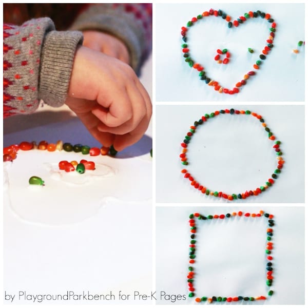 Child's hands placing colorful dyed corn kernels onto shapes made of glue