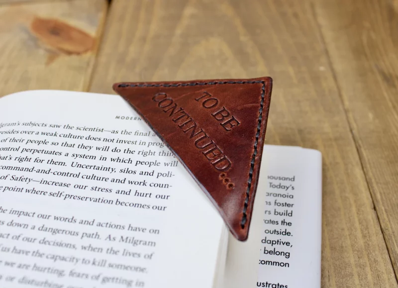 Leather corner bookmark on an open book.