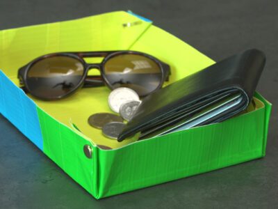 Neon colored tray made of duct tape holding wallet, keys, sunglasses