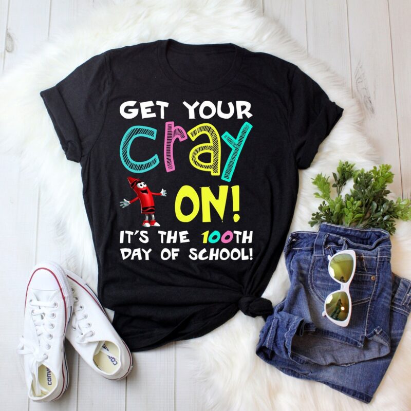 A black shirt says "Get Your Cray On. It's the 100th Day of School. There is a cartoon crayon man on it.