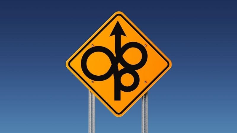 Yellow road sign showing twisted, confusing route ahead