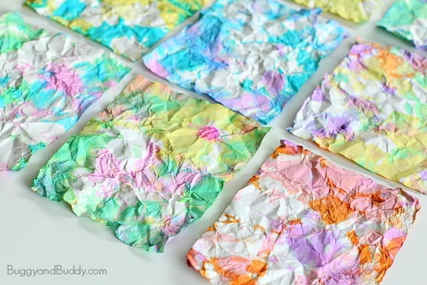 Crumpled pieces of paper dyed in colorful hues with watercolors