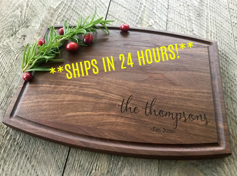 A dark wood cutting board is shown with a name engraved on it (gifts for paraprofessionals)