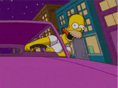 Homer Simpson driving with his head out the car window and tongue out