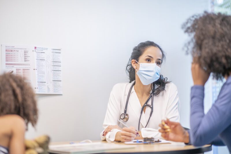 Woman doctor talking to patient - science career