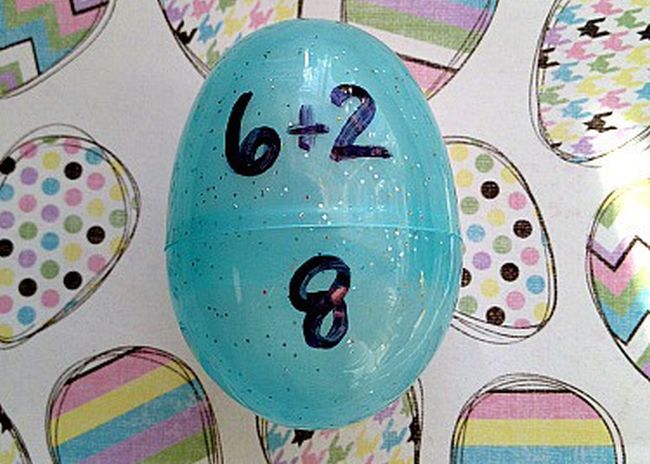 Blue plastic egg with "6+2" written on one half and "8" on the other