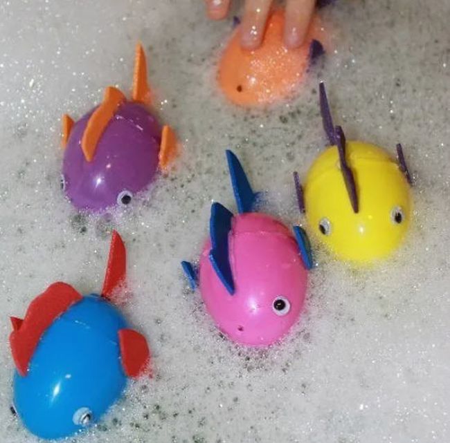 Floating fish made from plastic eggs in a tub of soapy water (Easter Egg Activities)