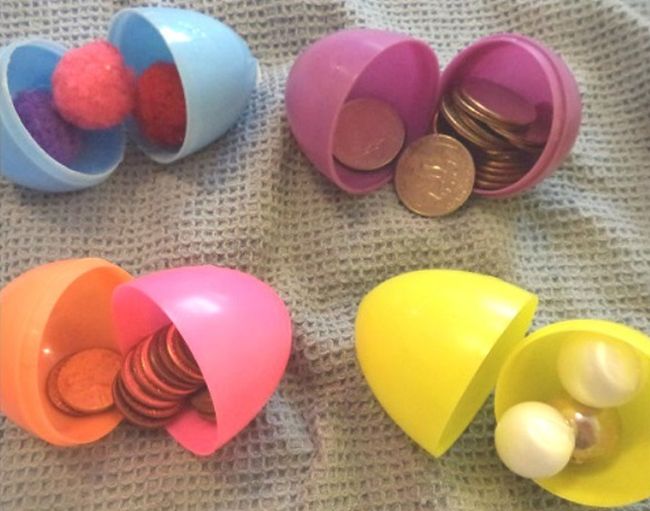 Easter eggs filled with coins, pom poms, and other materials (Easter Egg Activities)