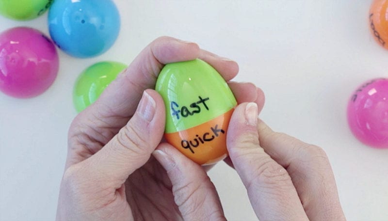 Hands twisting Easter egg with "fast" written on one half and "quick" on the other