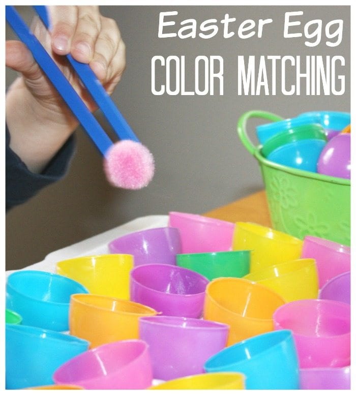 Child using plastic tweezers to sort colored pom pom into matching Easter egg halves