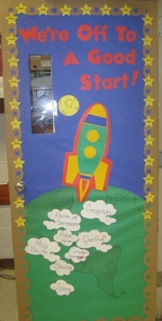 Door decoration of a rocket blasting off, saying "we're off to a good start!"
