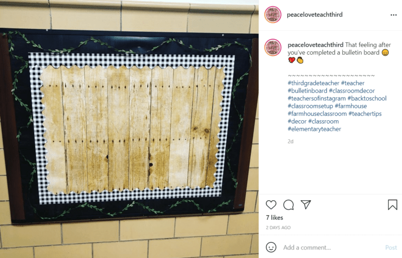 Bulletin board in a school hallway with a black frame, black and white checkered trip, and faux wood paneling in the middle.