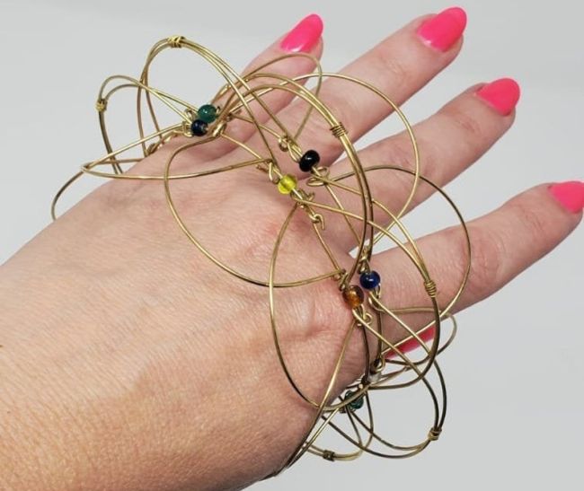 Student playing with a fidget toy bracelet made of wire circles and beads