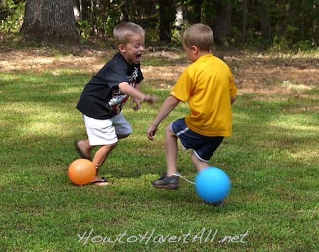 Kids with balloons tied to their ankles, trying to break each other's balloons