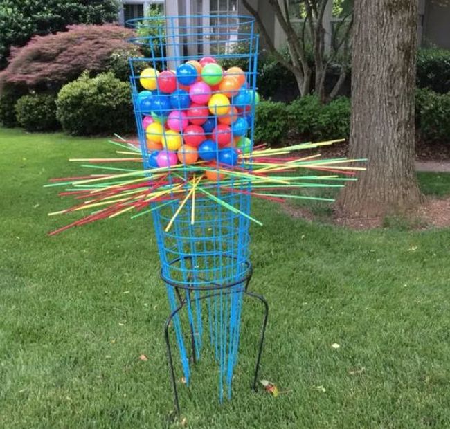 Giant Kerplunk game made from tomato cages, sticks, and colored balls