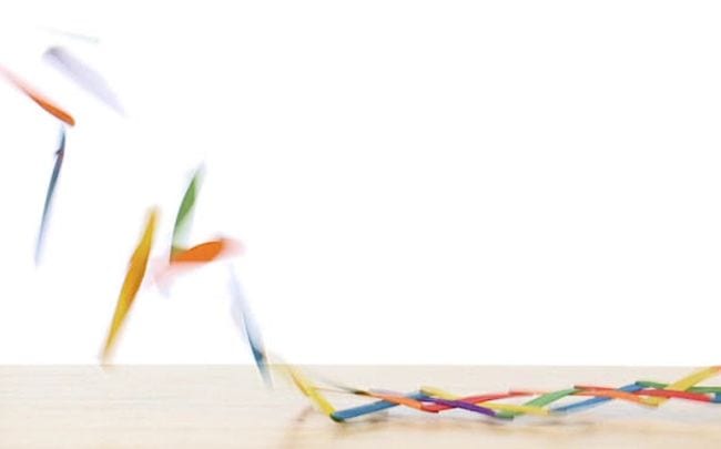 Colorful wood craft sticks flying into the air from a table