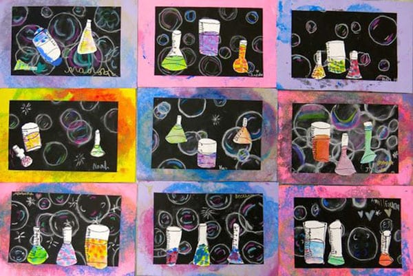 Mixed media first grade art projects showing chalk bubbles and paper beakers painted in various patterns