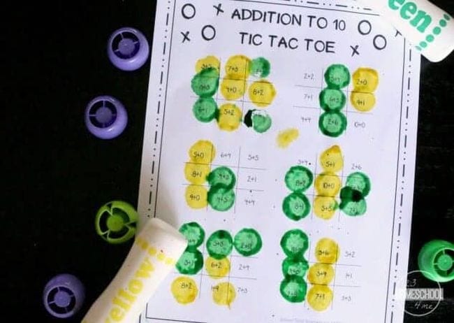 Tic-tac-toe boards with addition problems, filled in using bingo daubers (First Grade Math Games)