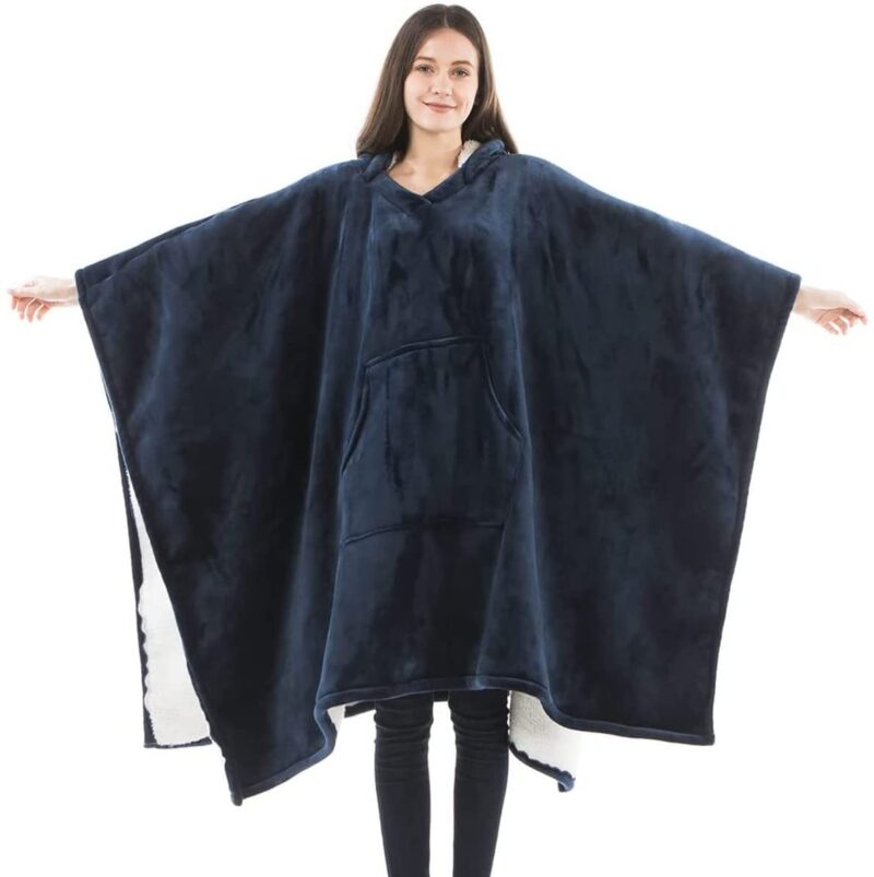 Woman in dark blue poncho-style wearable blanket