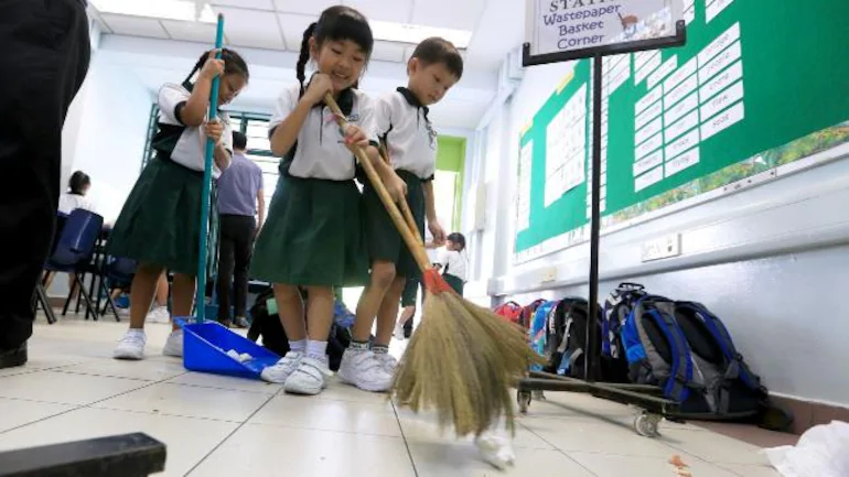 students sweep the classroom