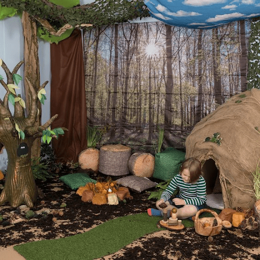 Child playing in forest-themed room