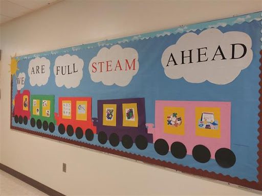 board with "we are full STEAM ahead" written on it
