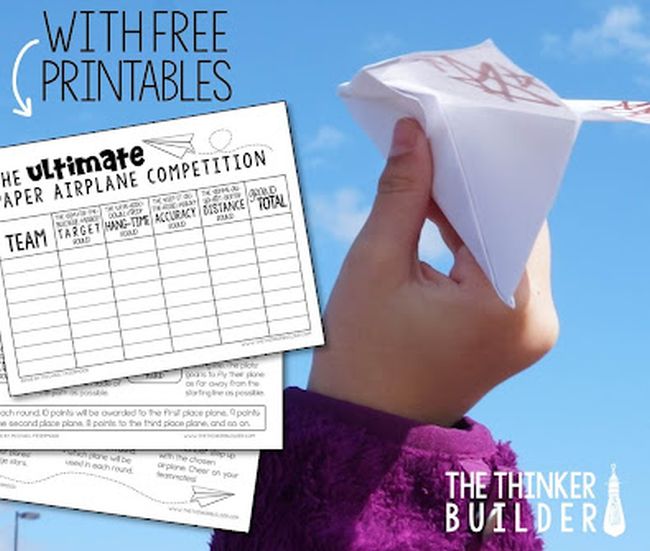 Student's hand holding a paper airplane, with free airplane printables