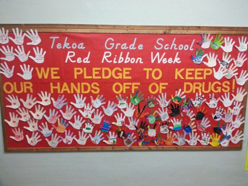 October bulletin board ideas like this one for red ribbon week says "we pledge to keep our hands off drugs. There are a lot of cut out hands surrounding the text.