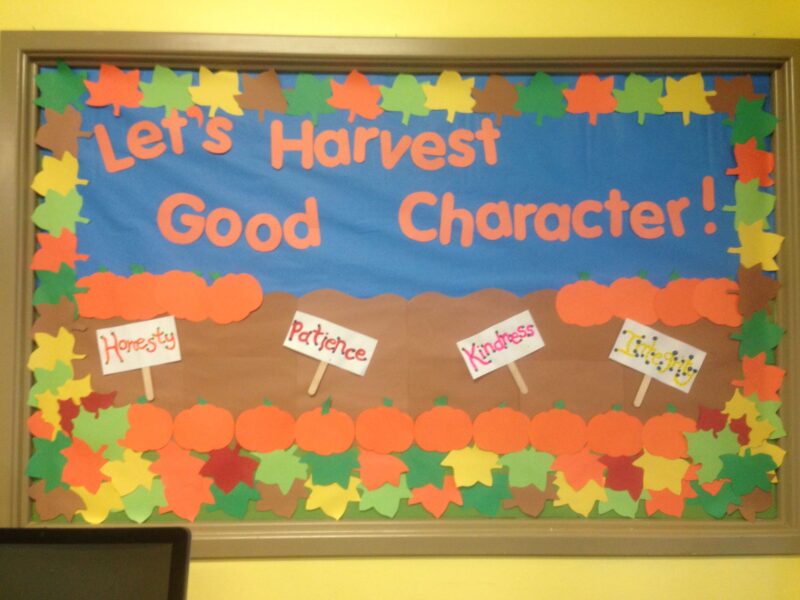 Fall bulletin boards can spread a positive message like this one that reads "Let's Harvest Good Character!" There are pumpkins and leaves and signs that say things like kindness.