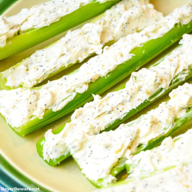 Celery sticks stuffed with cream cheese sprinkled with Everything Bagel seasoning