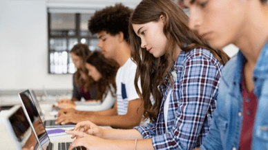 High school students typing on computers