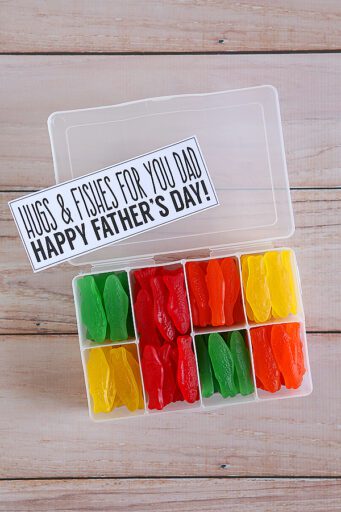 Tackle box filled with Swedish Fish and a tag that says, "Hugs and Fishes for You Dad.  Happy Father's Day!"as an example of the best father's day crafts for kids
