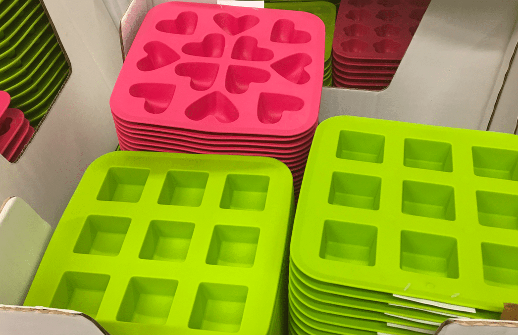 silicone ice trays in bright green squares and hot pink heart shapes